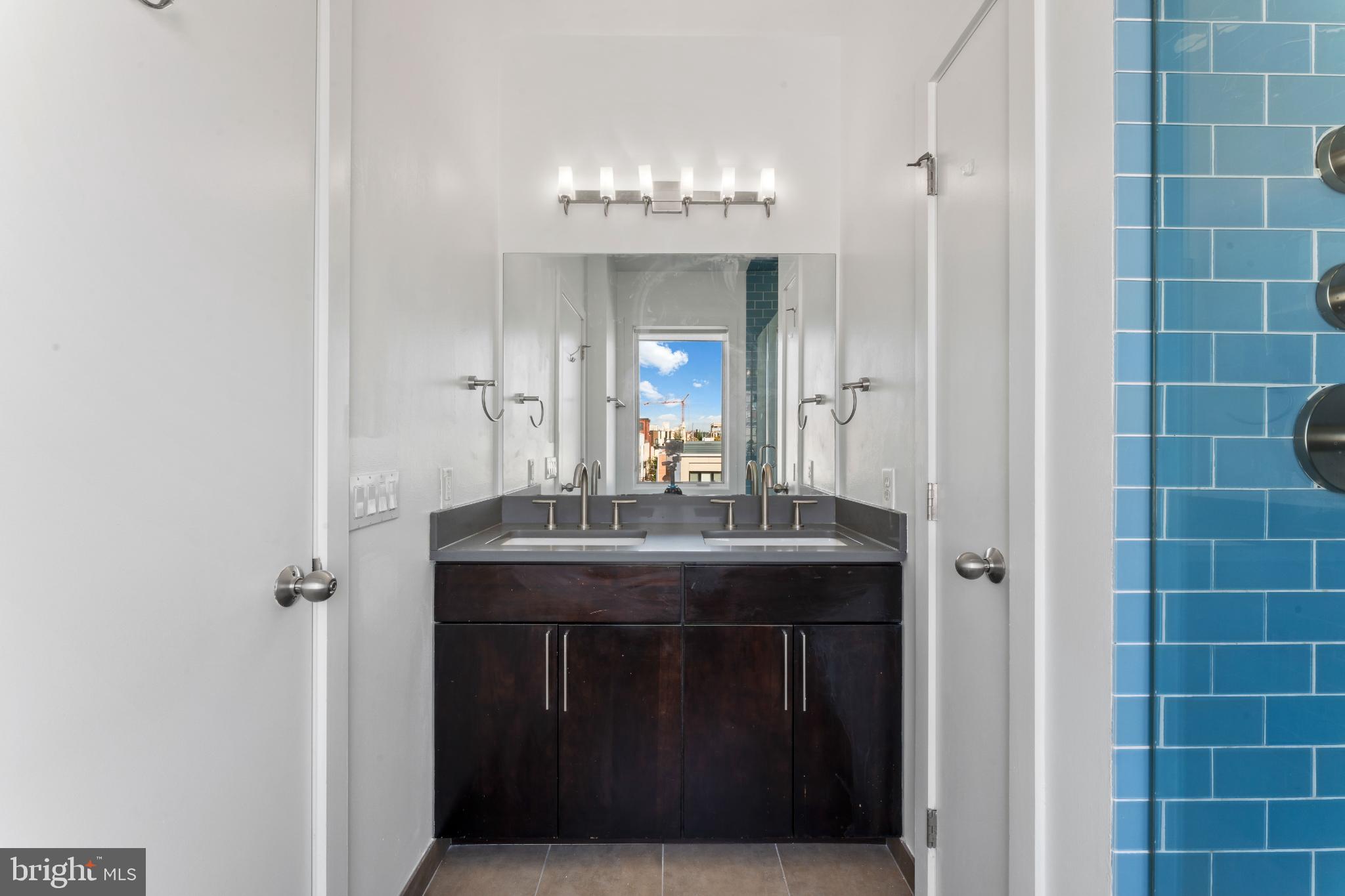 333 Green Street, Unit 7 Philadelphia, PA 19123 - Photo 30 of 40 Modern bathroom with vibrant blue accents.