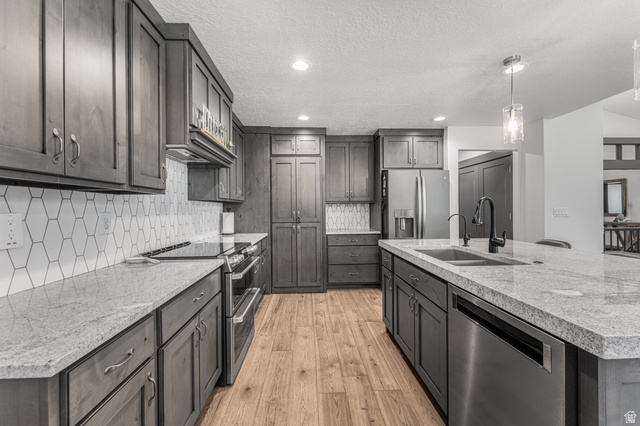 313 Old Maple Road South Weber, UT 84405 - Photo 11 of 35 Contemporary kitchen with gray cabinetry, light-toned countertops, and stainless steel appliances