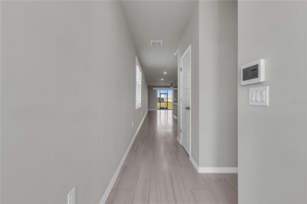 44254 Frontier Drive Punta Gorda, FL 33982 - Photo 3 of 48 a view of a hallway with wooden floor