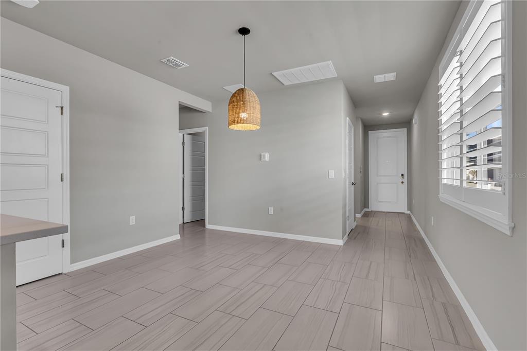 44254 Frontier Drive Punta Gorda, FL 33982 - Photo 7 of 48 a view of an empty room with window and wooden floor