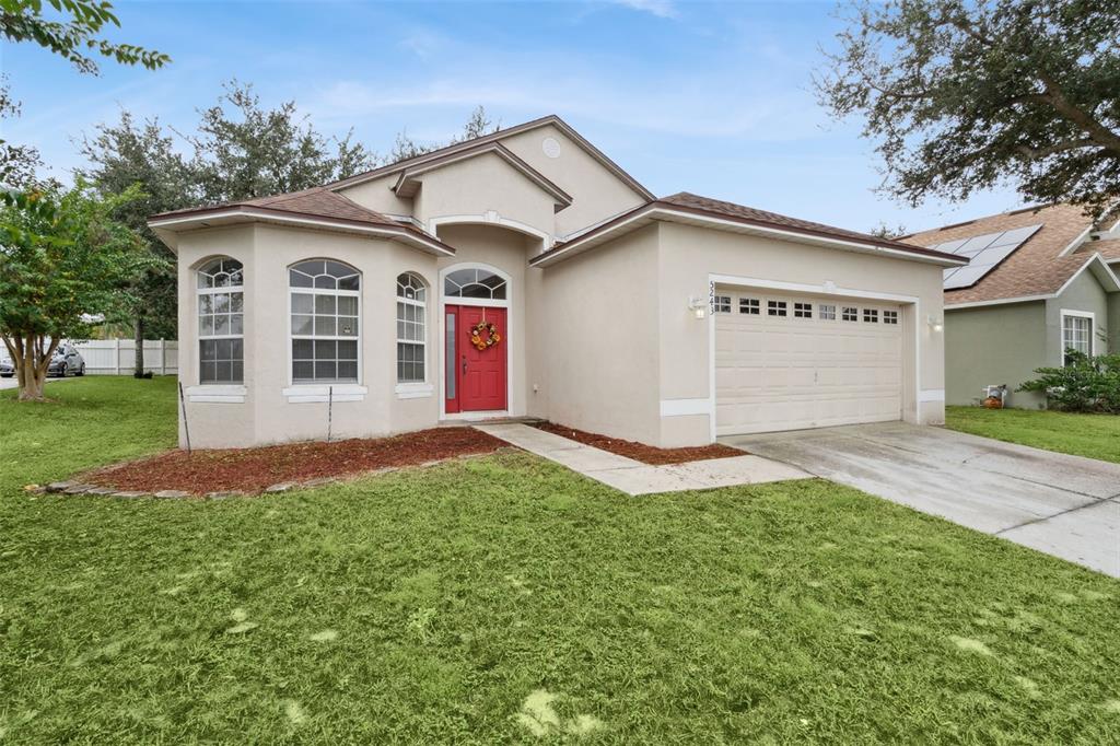 a front view of a house with a yard and garage