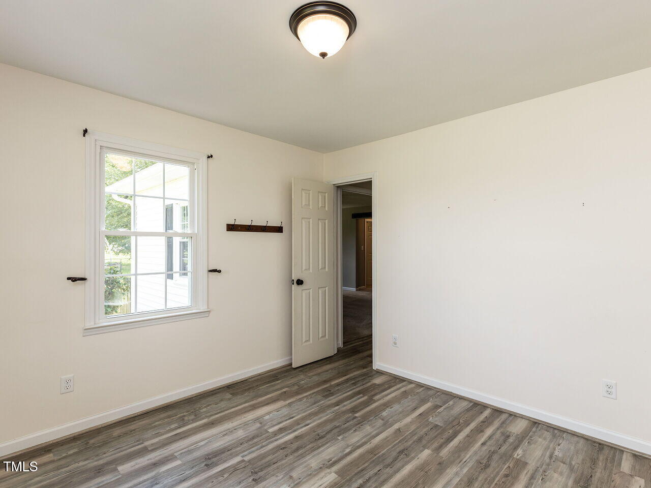 10336 Old Beulah Road Kenly, NC 27542 - Photo 11 of 71 an empty room with wooden floor and windows