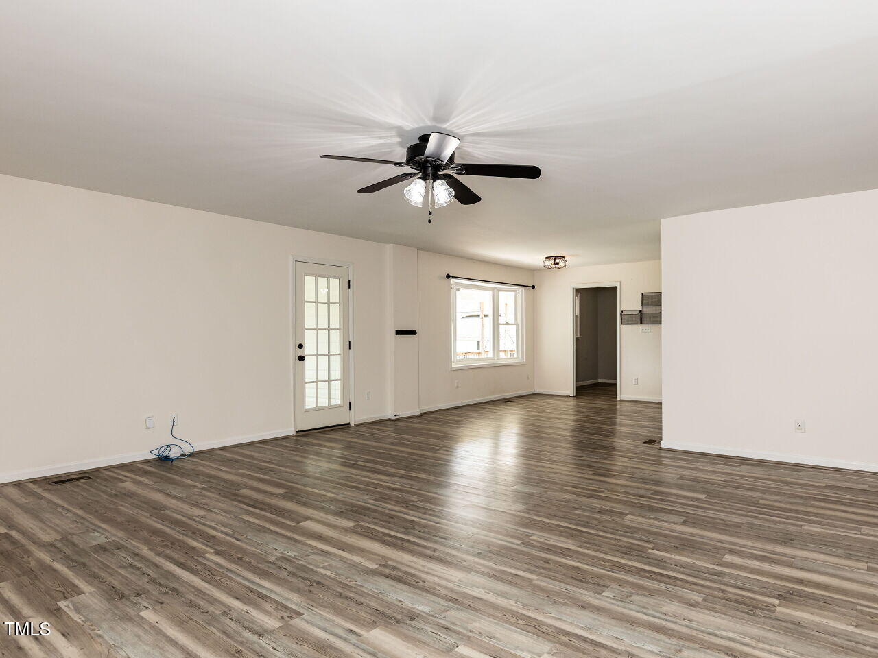 10336 Old Beulah Road Kenly, NC 27542 - Photo 14 of 71 a view of empty room with wooden floor and fan