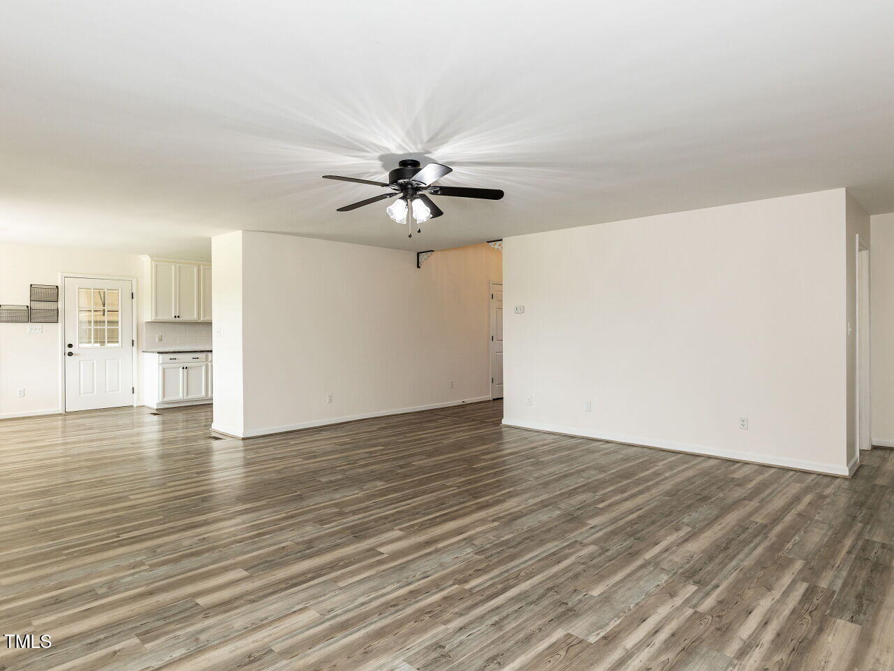10336 Old Beulah Road Kenly, NC 27542 - Photo 15 of 71 a view of a kitchen with wooden floor and a ceiling fan
