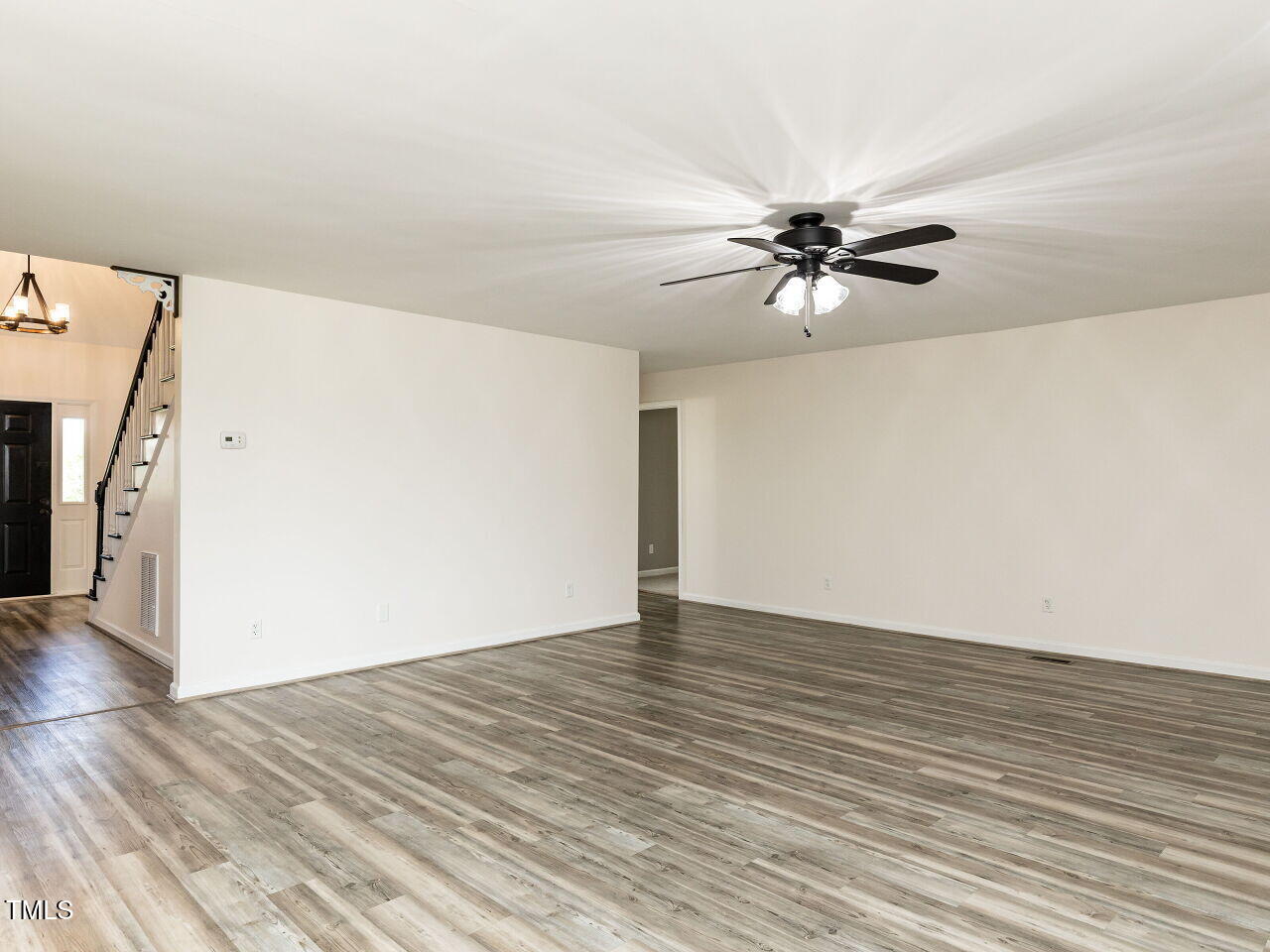 10336 Old Beulah Road Kenly, NC 27542 - Photo 16 of 71 an empty room with wooden floor and a ceiling fan