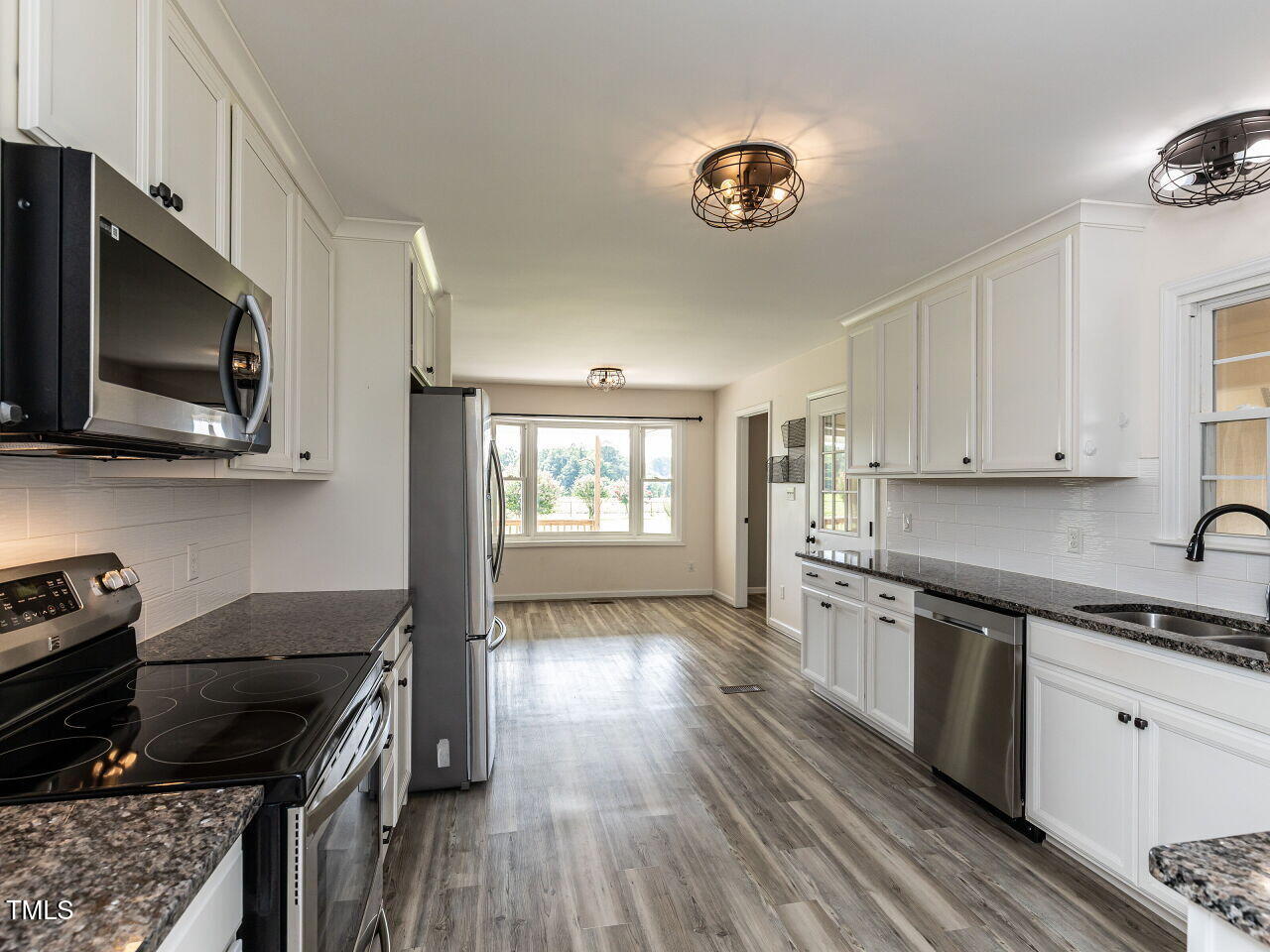 10336 Old Beulah Road Kenly, NC 27542 - Photo 19 of 71 a kitchen with stainless steel appliances granite countertop a stove and a sink