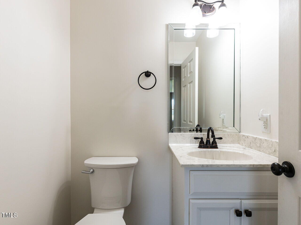 10336 Old Beulah Road Kenly, NC 27542 - Photo 22 of 71 a bathroom with a sink a toilet and a mirror
