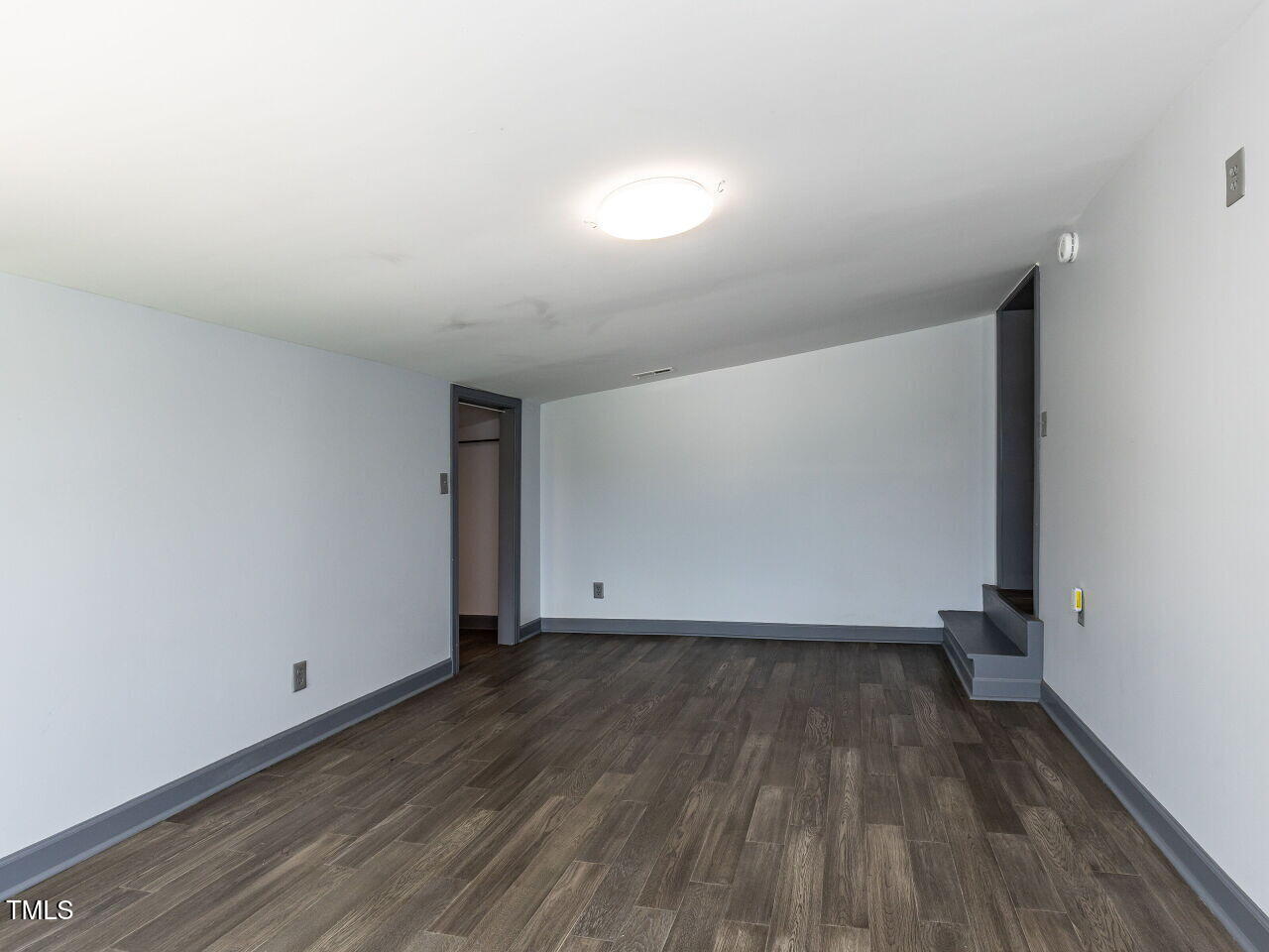 10336 Old Beulah Road Kenly, NC 27542 - Photo 61 of 71 a view of an empty room with wooden floor and a window