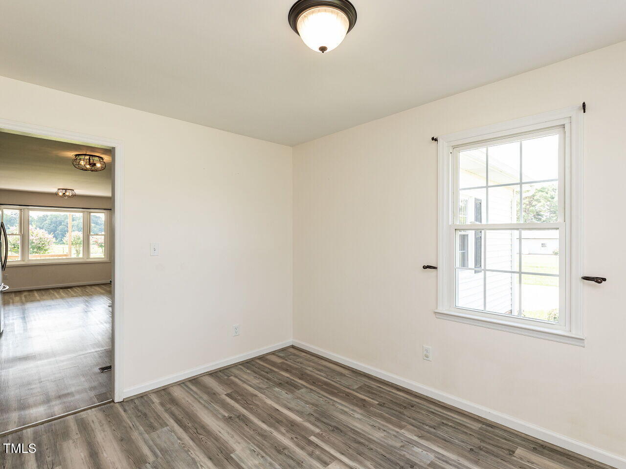 10336 Old Beulah Road Kenly, NC 27542 - Photo 8 of 71 an empty room with wooden floor and windows