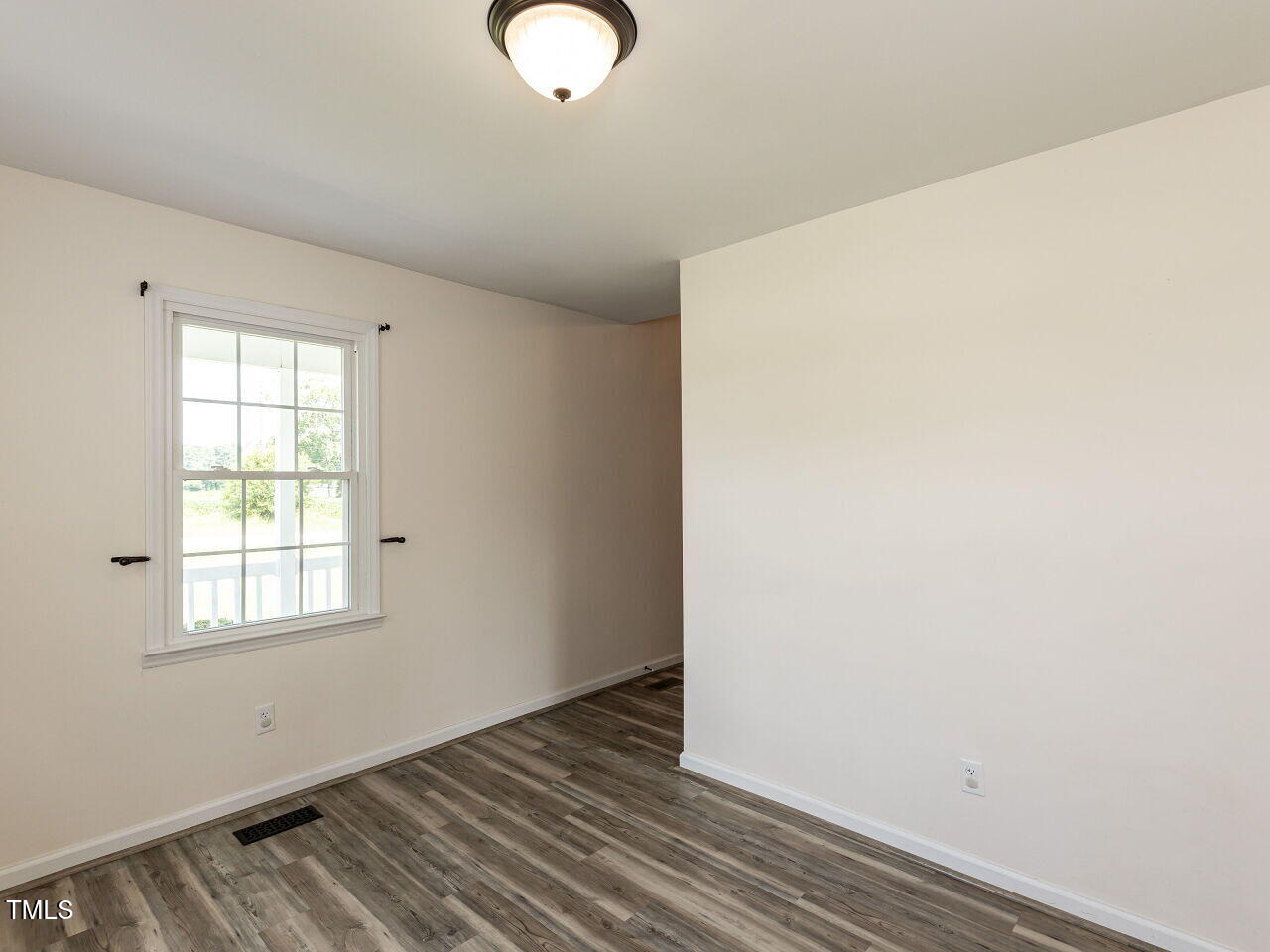 10336 Old Beulah Road Kenly, NC 27542 - Photo 9 of 71 an empty room with wooden floor and windows