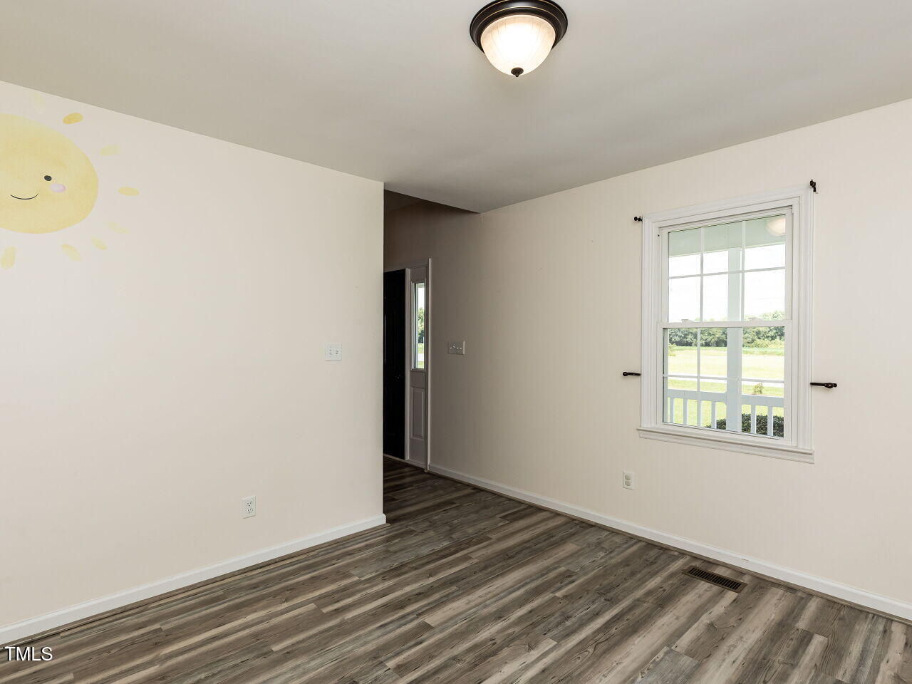 10336 Old Beulah Road Kenly, NC 27542 - Photo 10 of 71 an empty room with wooden floor and windows
