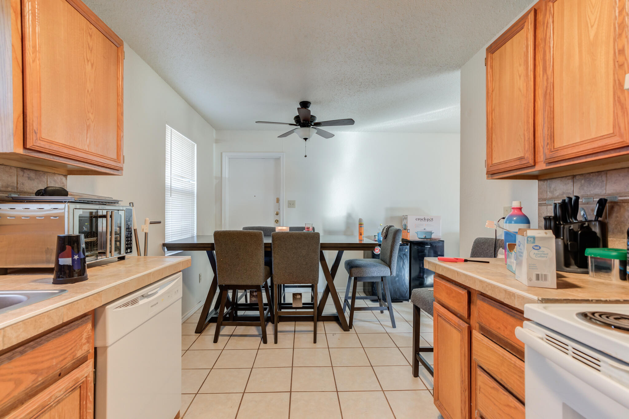 6210 22nd Street Lubbock, TX 79407 - Photo 12 of 18 a kitchen with stainless steel appliances a table chairs and a refrigerator