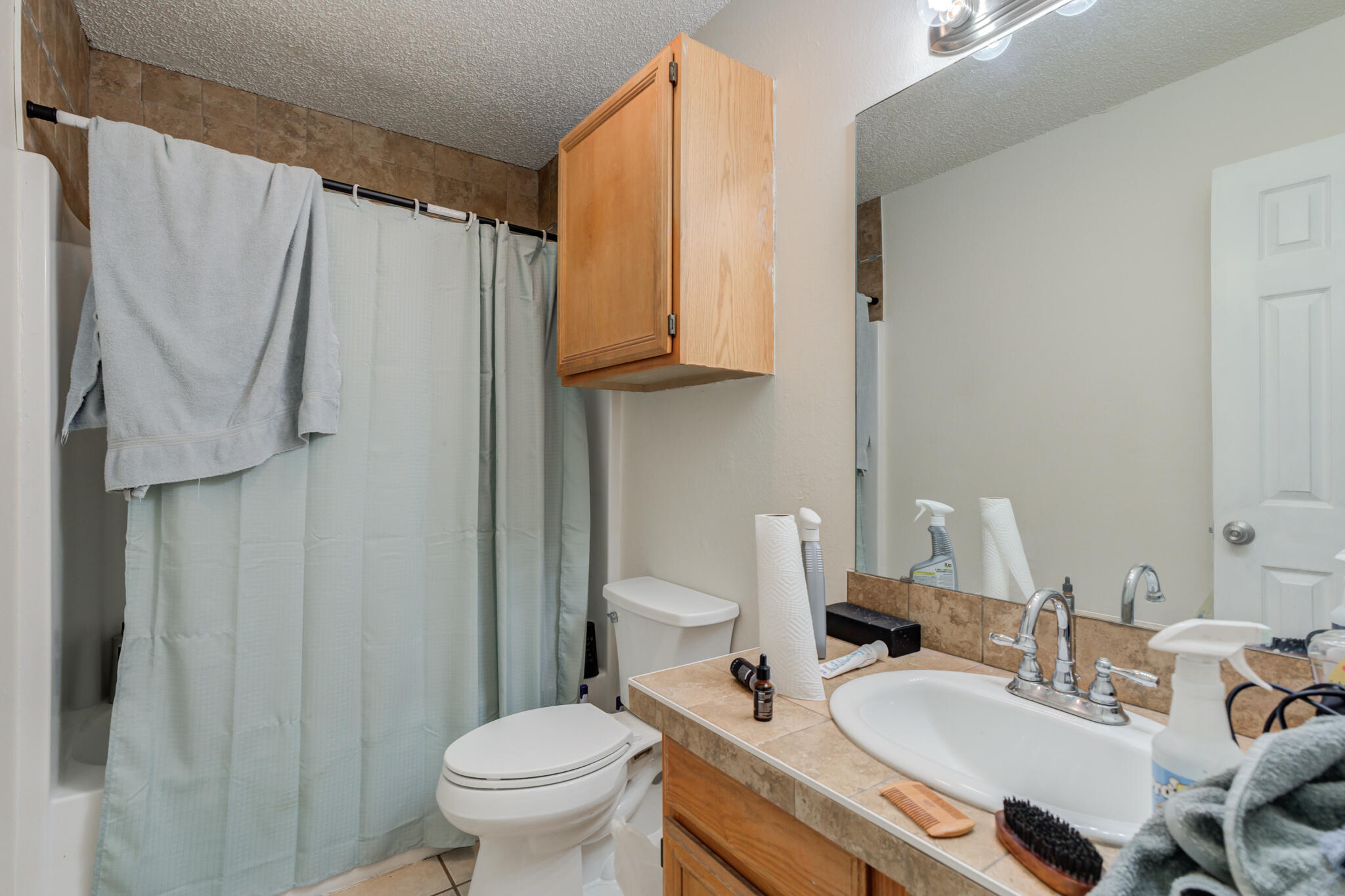6210 22nd Street Lubbock, TX 79407 - Photo 15 of 18 a bathroom with a sink toilet and shower