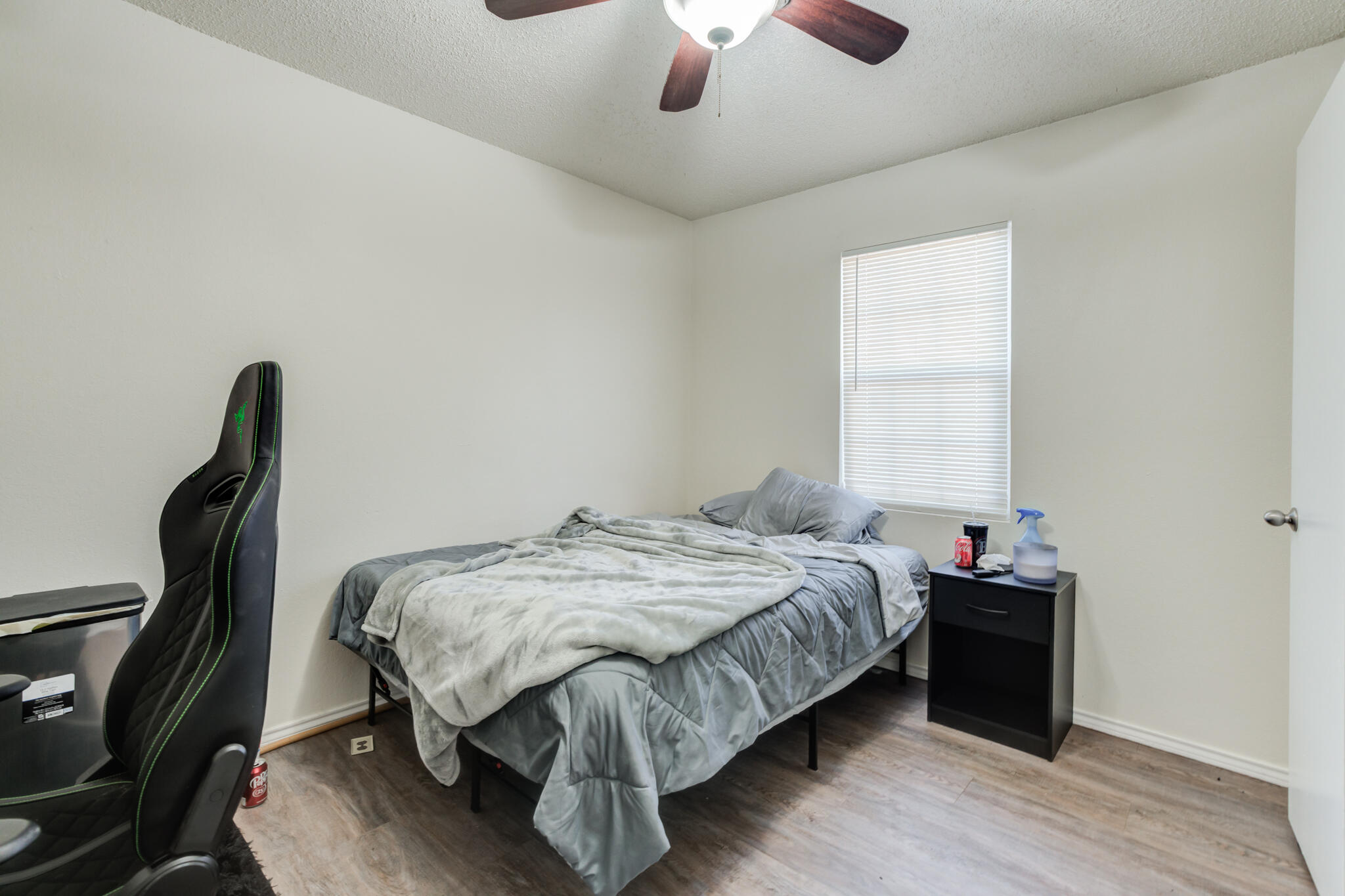 6210 22nd Street Lubbock, TX 79407 - Photo 16 of 18 a bedroom with a bed and a chandelier