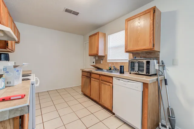 a kitchen with a sink cabinets and window