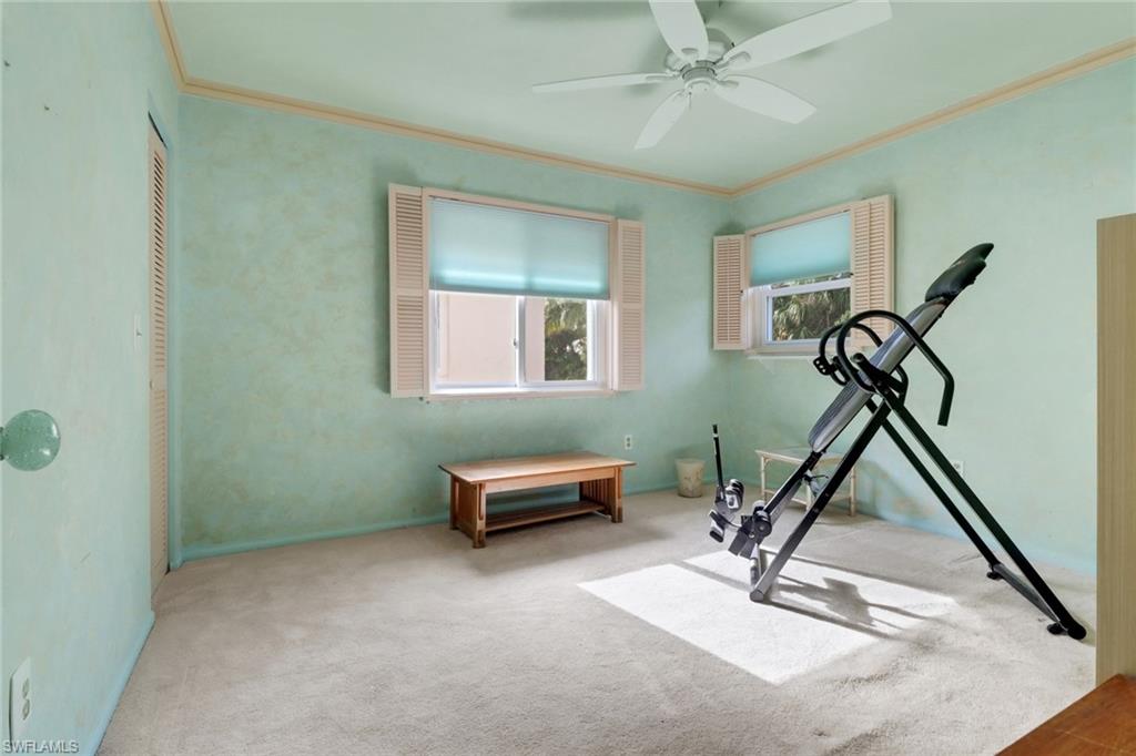 1155 Sandpiper Street, Unit D4 Naples, FL 34102 - Photo 16 of 39 Exercise area with crown molding, ceiling fan, and carpet floors