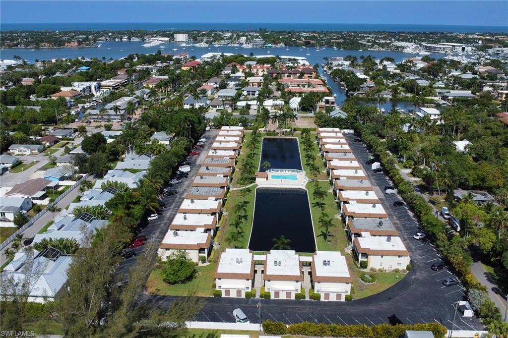1155 Sandpiper Street, Unit D4 Naples, FL 34102 - Photo 22 of 39 Aerial overview of property's location with nearby suburban area and a nearby body of water
