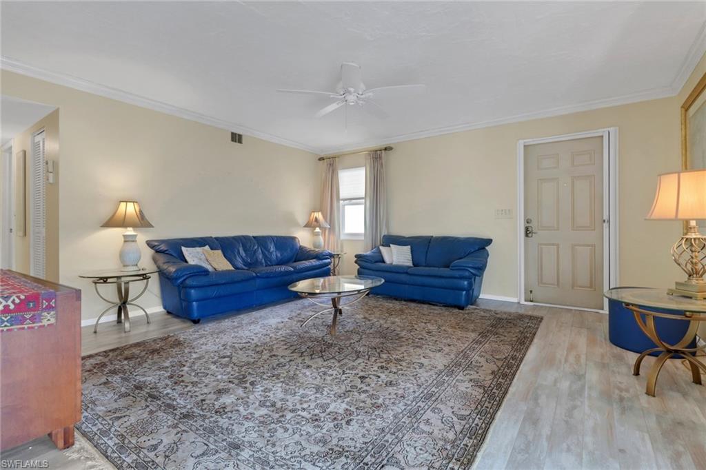 1155 Sandpiper Street, Unit D4 Naples, FL 34102 - Photo 27 of 39 Living room featuring ceiling fan, wood finished floors, and crown molding