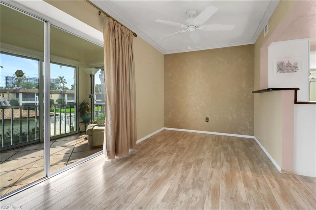 1155 Sandpiper Street, Unit D4 Naples, FL 34102 - Photo 29 of 39 Unfurnished room with wood finished floors, ceiling fan, and crown molding