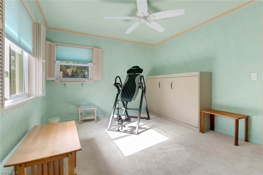1155 Sandpiper Street, Unit D4 Naples, FL 34102 - Photo 34 of 39 Exercise room featuring crown molding, a ceiling fan, and carpet floors