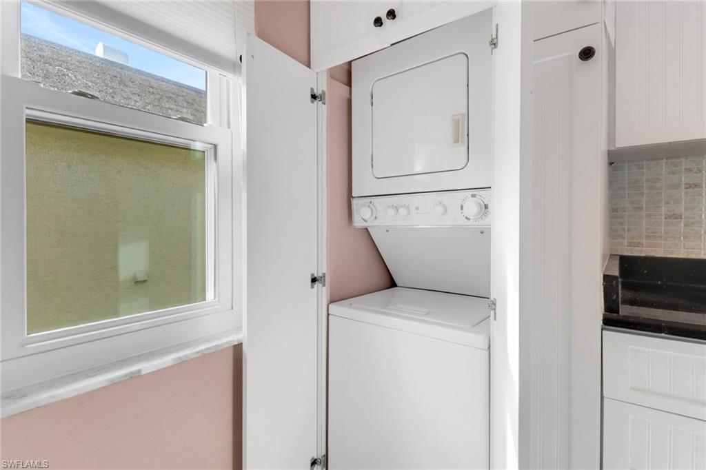 1155 Sandpiper Street, Unit D4 Naples, FL 34102 - Photo 35 of 39 Laundry area with stacked washer and clothes dryer