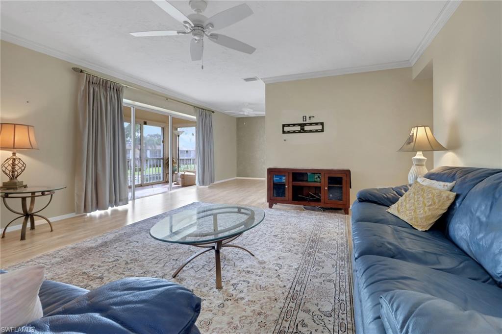 1155 Sandpiper Street, Unit D4 Naples, FL 34102 - Photo 5 of 39 Living room featuring ornamental molding, wood finished floors, and ceiling fan