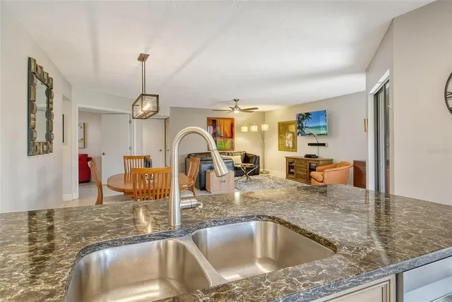 a view of kitchen with furniture and refrigerator