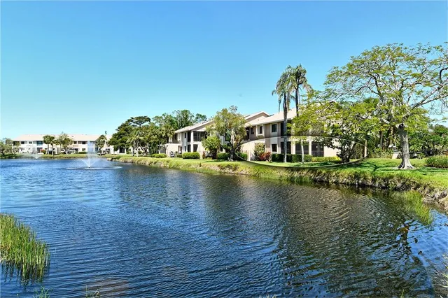 a view of roof deck with table and chairs under an umbrella