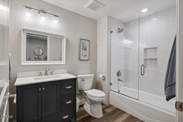 a bathroom with a toilet sink and shower