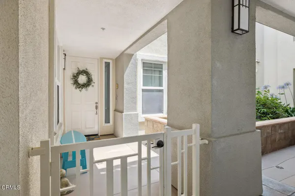 a view of a porch with wooden floor and front door