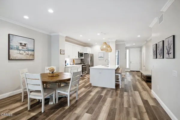 a view of a dining room with furniture and wooden floor