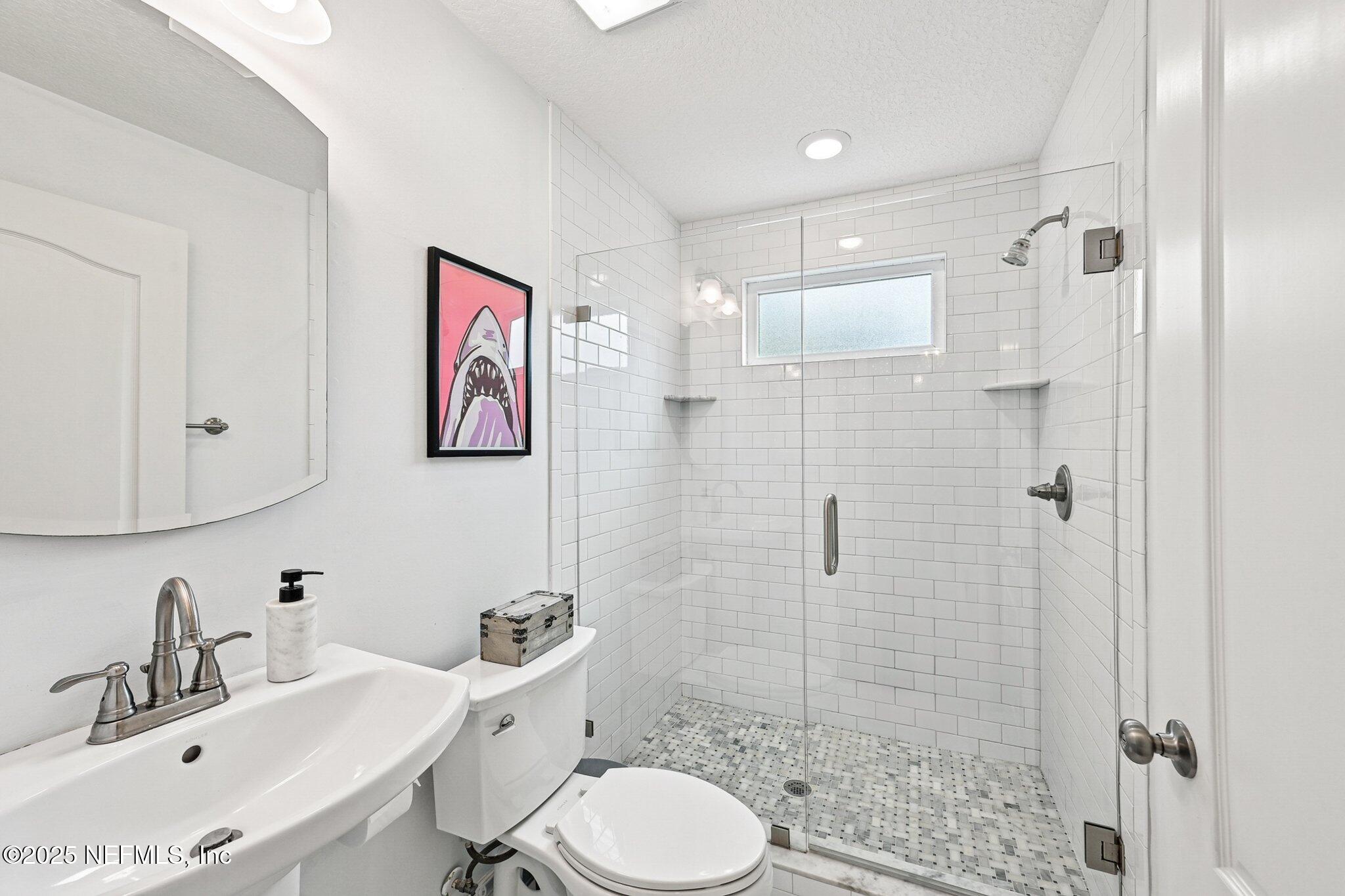 4637 Homestead Road Jacksonville, FL 32210 - Photo 16 of 43 a bathroom with a sink toilet and shower