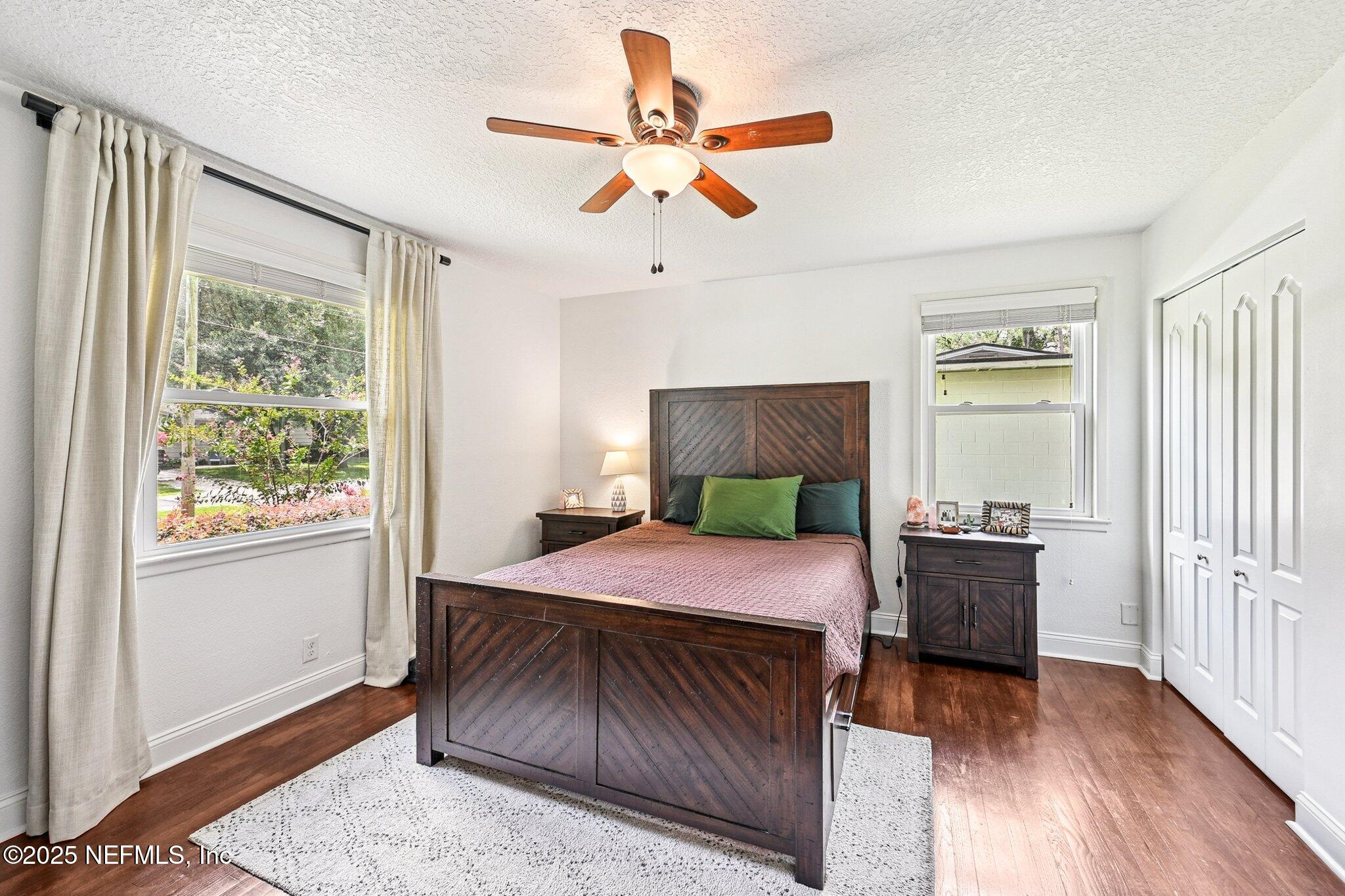 4637 Homestead Road Jacksonville, FL 32210 - Photo 22 of 43 a bedroom with a bed and wooden floor