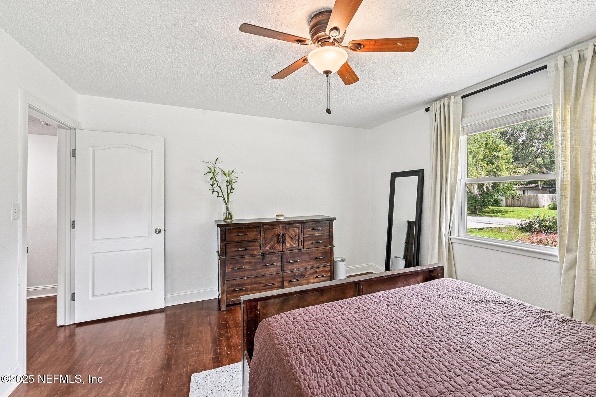 4637 Homestead Road Jacksonville, FL 32210 - Photo 23 of 43 a bedroom with a bed chandelier and a window