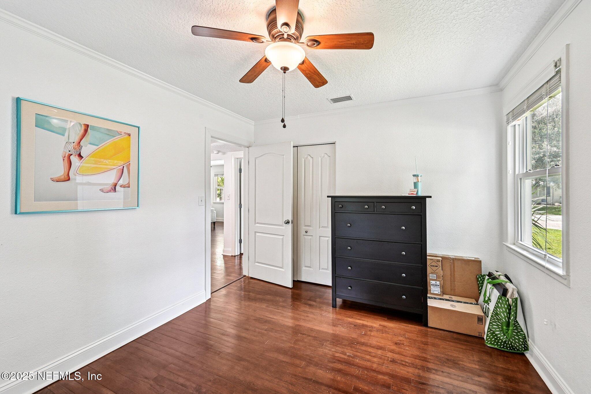 4637 Homestead Road Jacksonville, FL 32210 - Photo 26 of 43 a room with a dresser and a chandelier