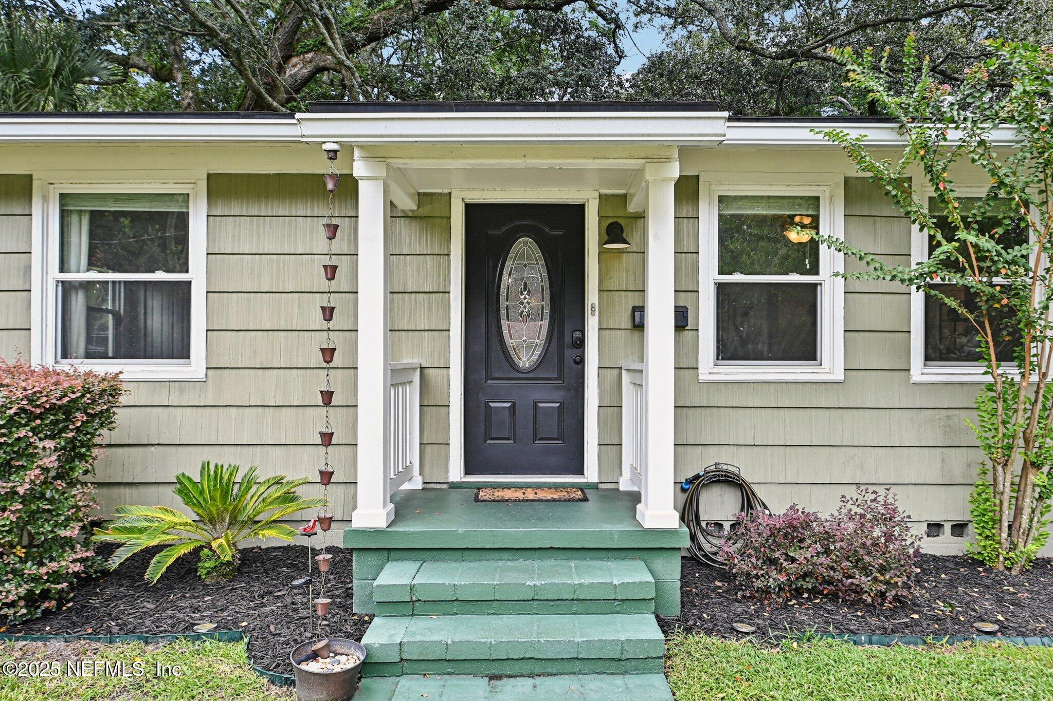 4637 Homestead Road Jacksonville, FL 32210 - Photo 3 of 43 a front view of a house with garden
