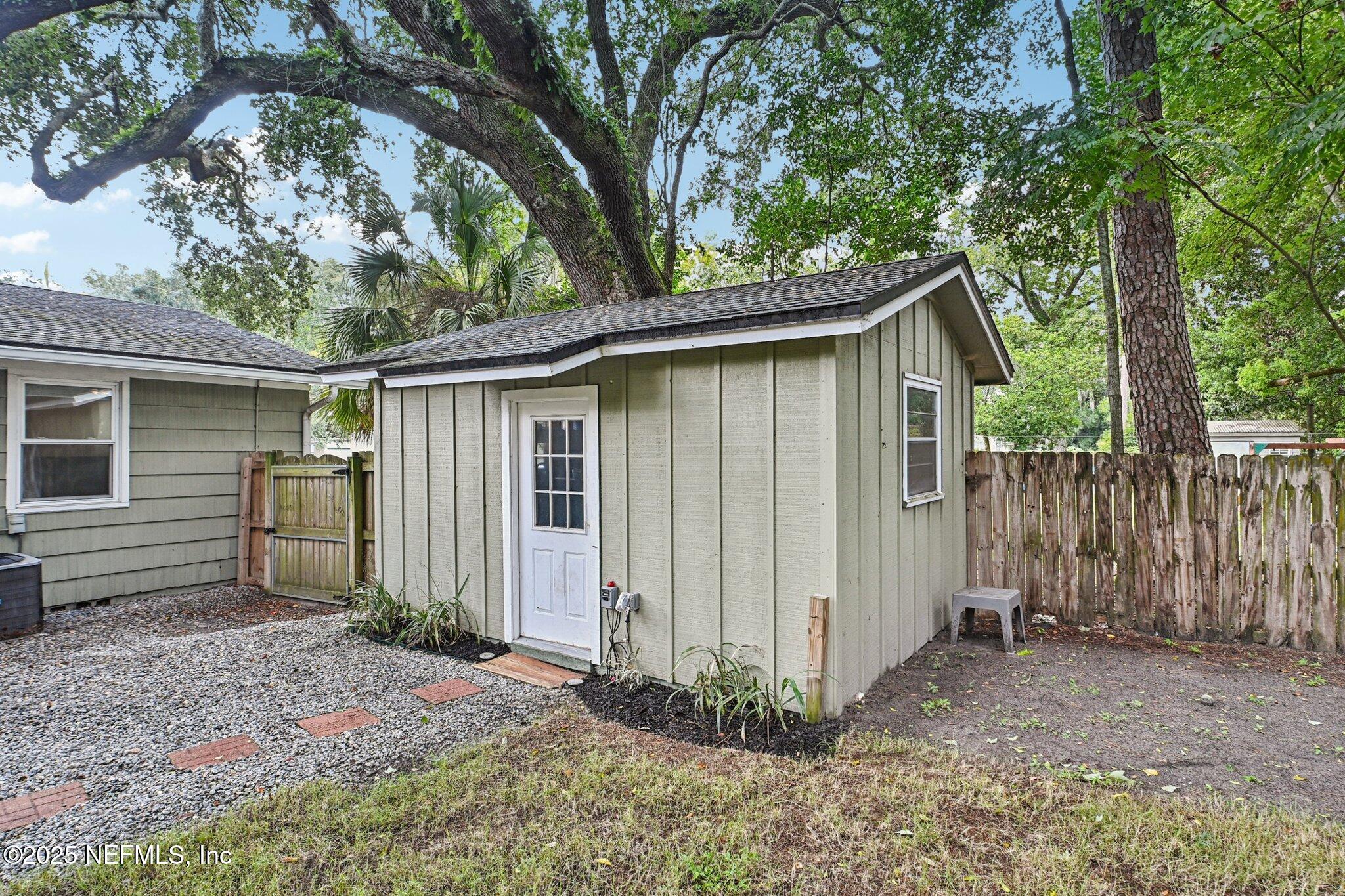 4637 Homestead Road Jacksonville, FL 32210 - Photo 33 of 43 a view of a house with a small yard plants and large tree