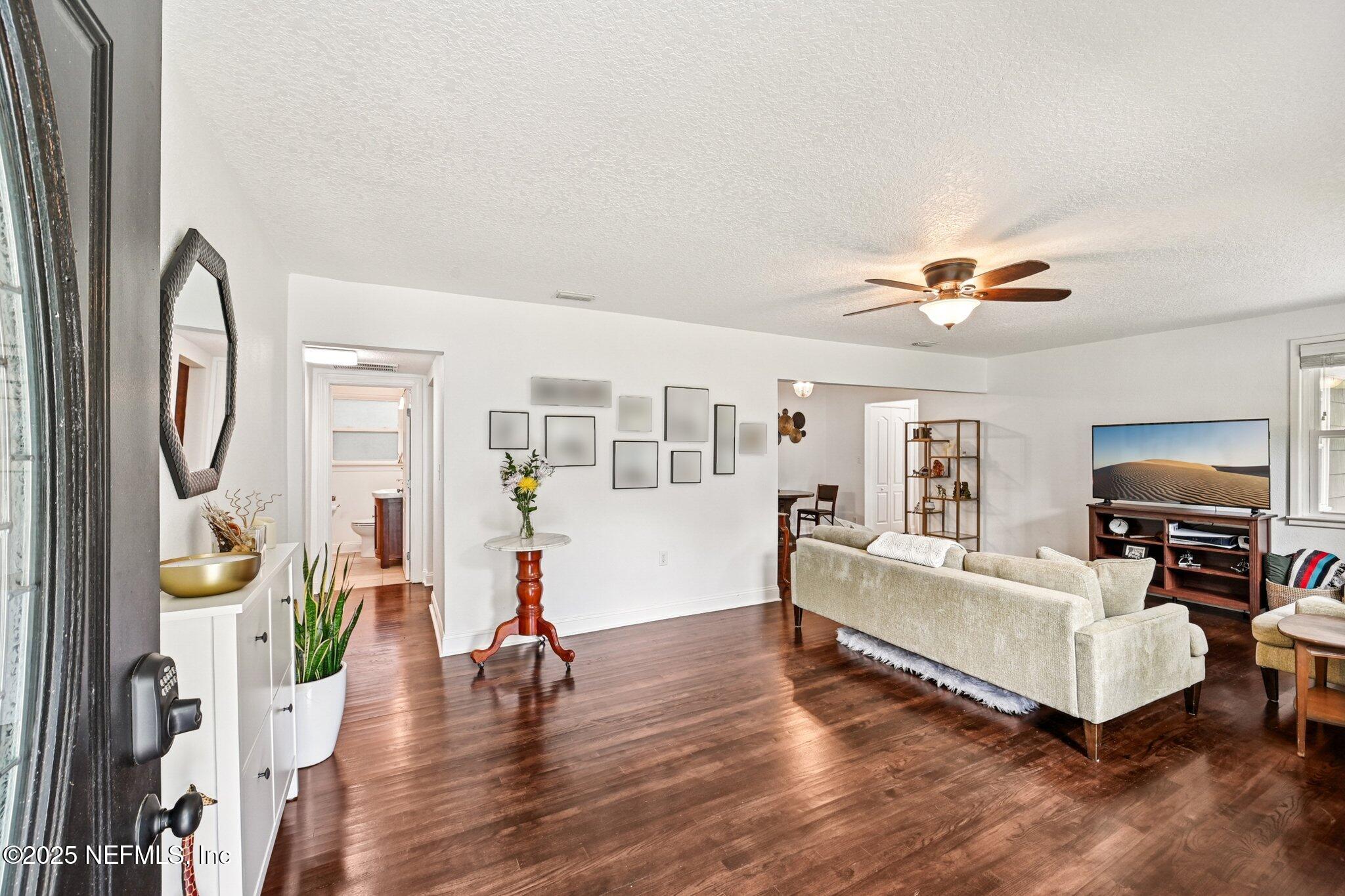 4637 Homestead Road Jacksonville, FL 32210 - Photo 4 of 43 a living room with furniture and a flat screen tv