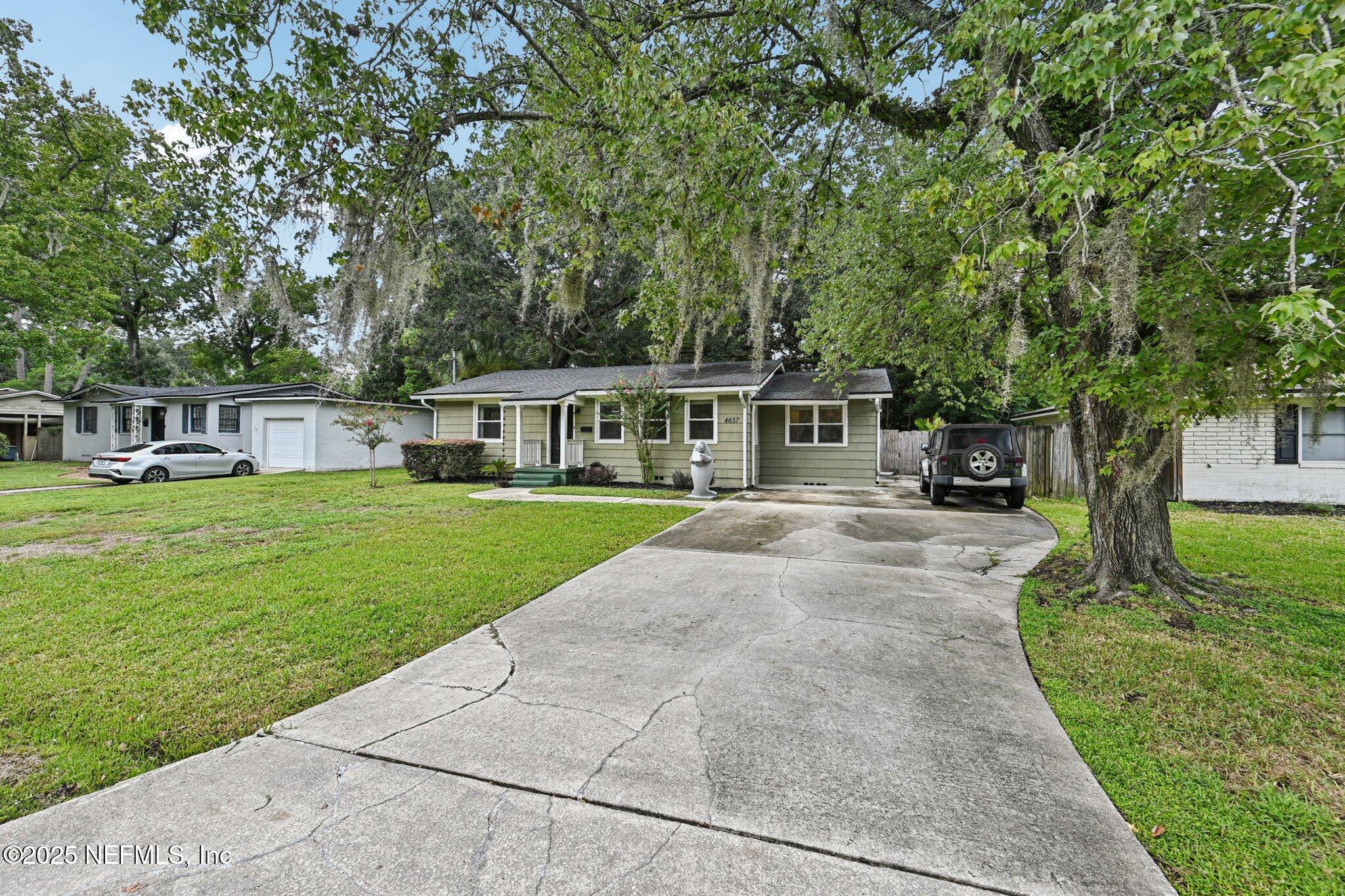 4637 Homestead Road Jacksonville, FL 32210 - Photo 41 of 43 front view of a house with a yard