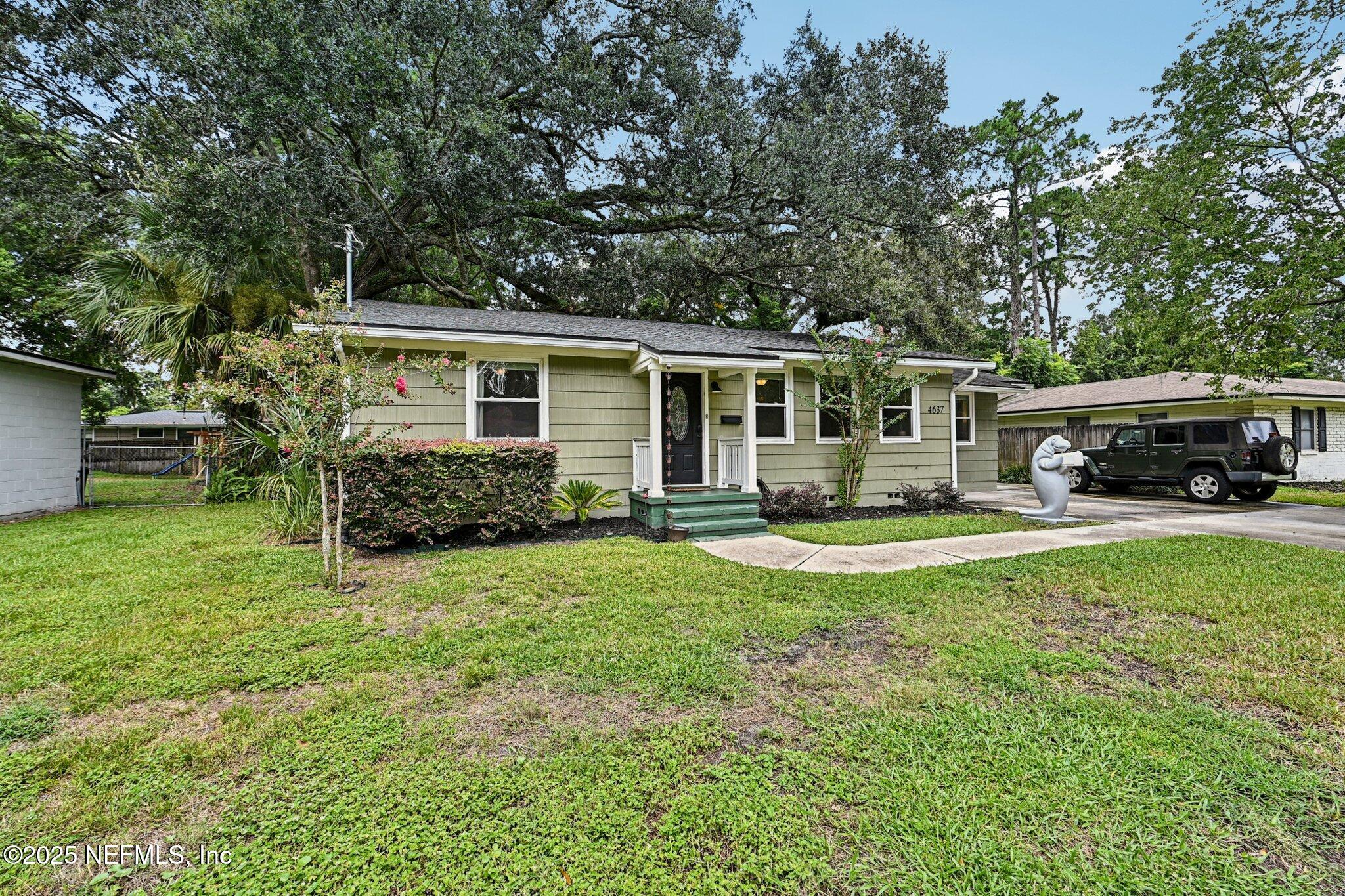 4637 Homestead Road Jacksonville, FL 32210 - Photo 42 of 43 a front view of a house with a garden