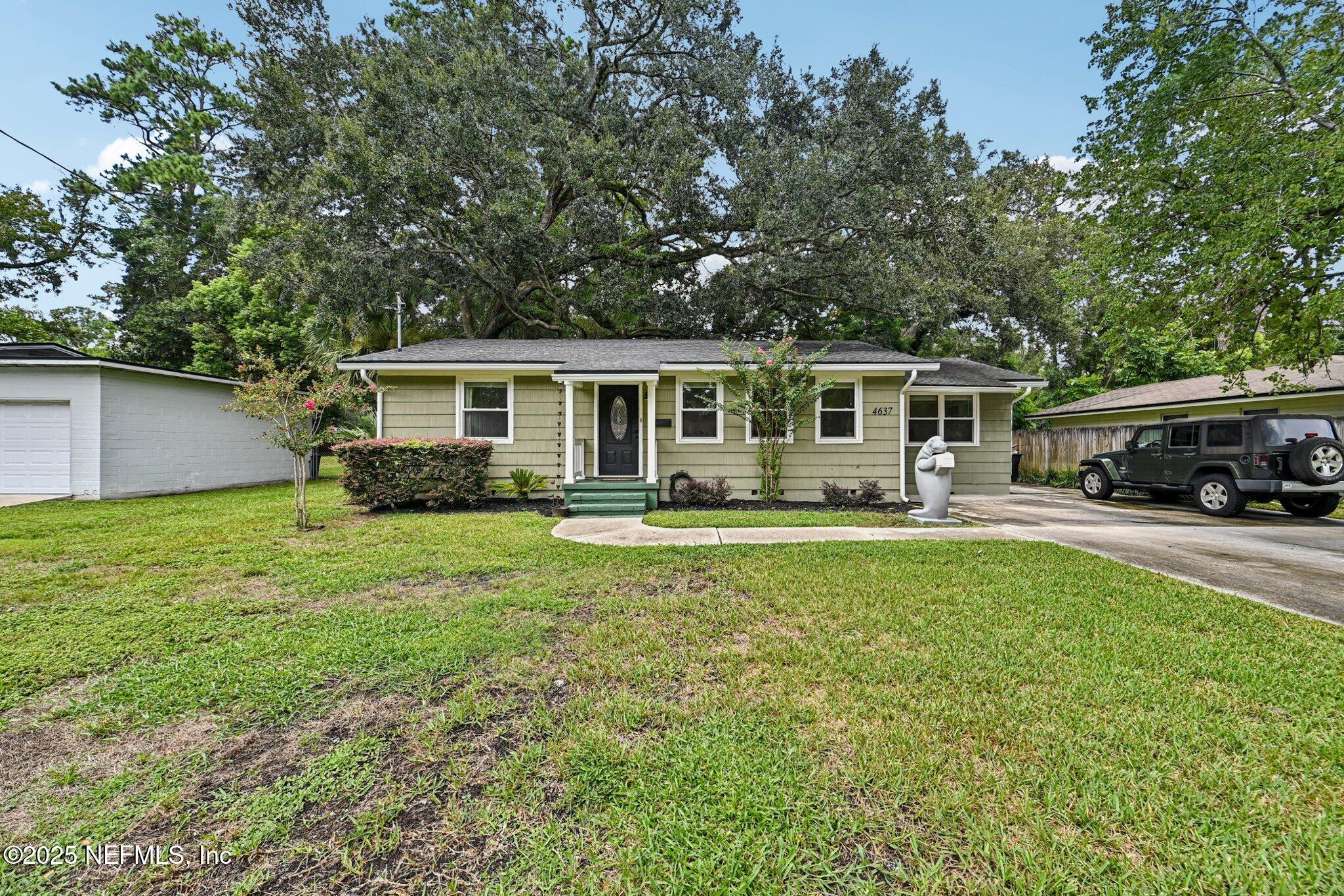 4637 Homestead Road Jacksonville, FL 32210 - Photo 43 of 43 a front view of a house with a yard table and chairs