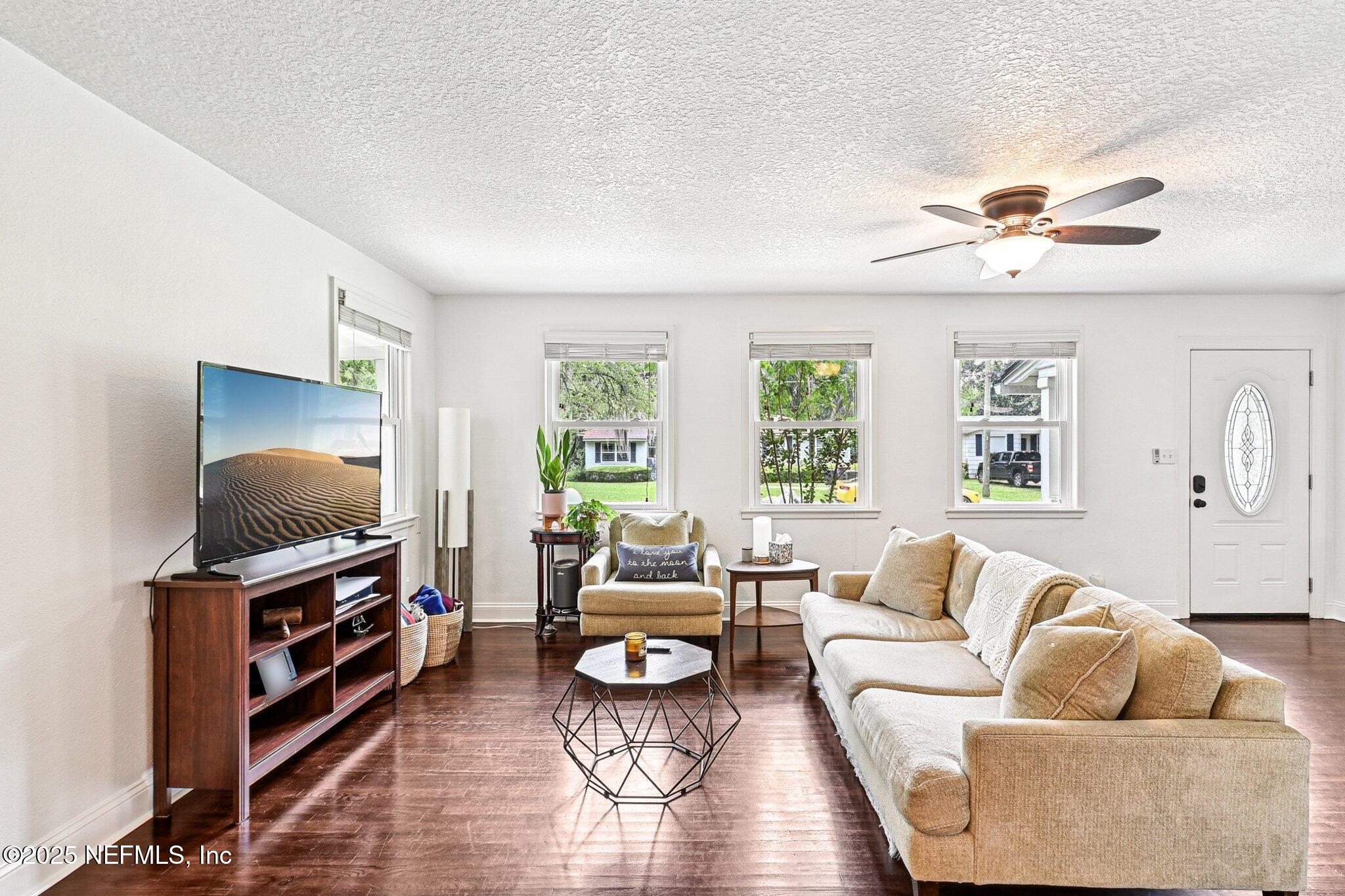 4637 Homestead Road Jacksonville, FL 32210 - Photo 6 of 43 a living room with furniture and a flat screen tv