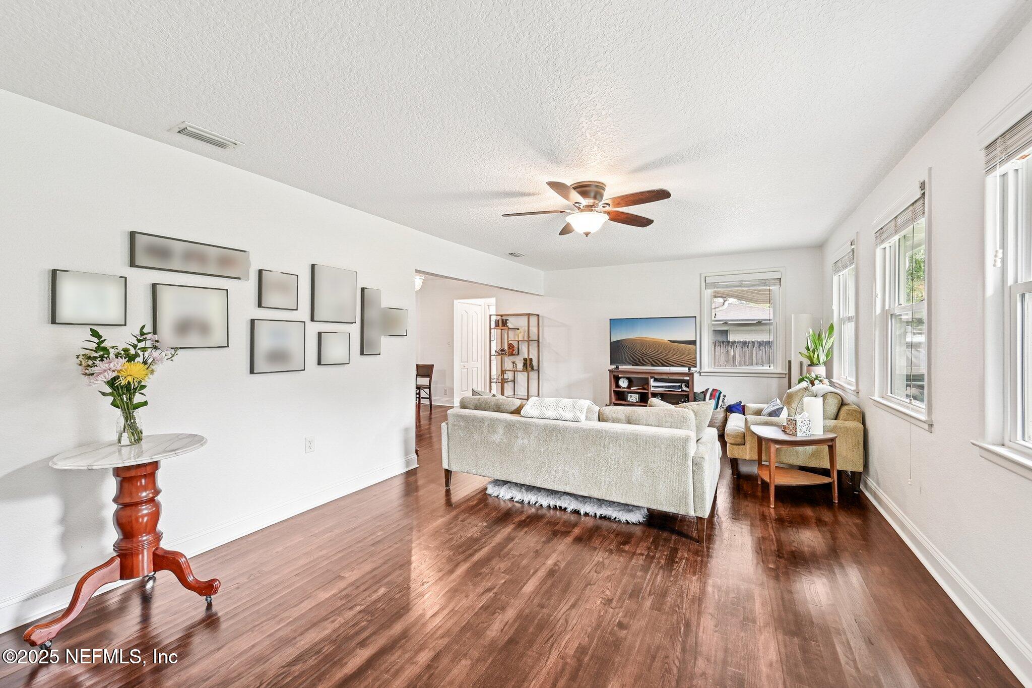 4637 Homestead Road Jacksonville, FL 32210 - Photo 7 of 43 a living room with furniture and a wooden floor