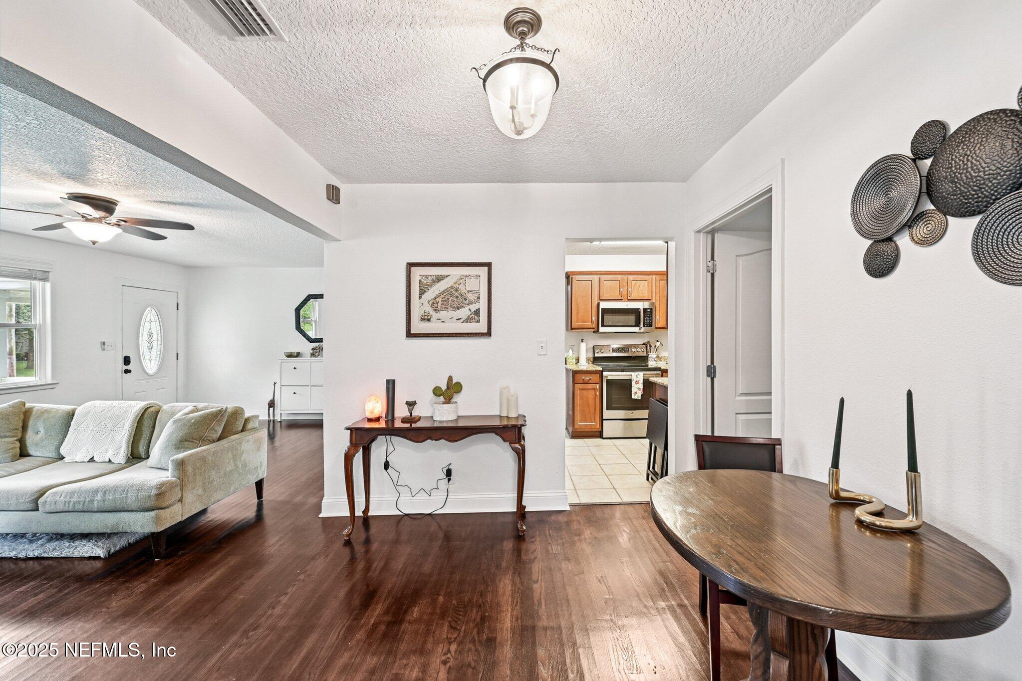 4637 Homestead Road Jacksonville, FL 32210 - Photo 10 of 43 a living room with furniture and wooden floor