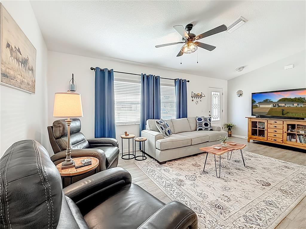 4445 East Maryland Street Inverness, FL 34453 - Photo 14 of 46 a living room with furniture and a flat screen tv