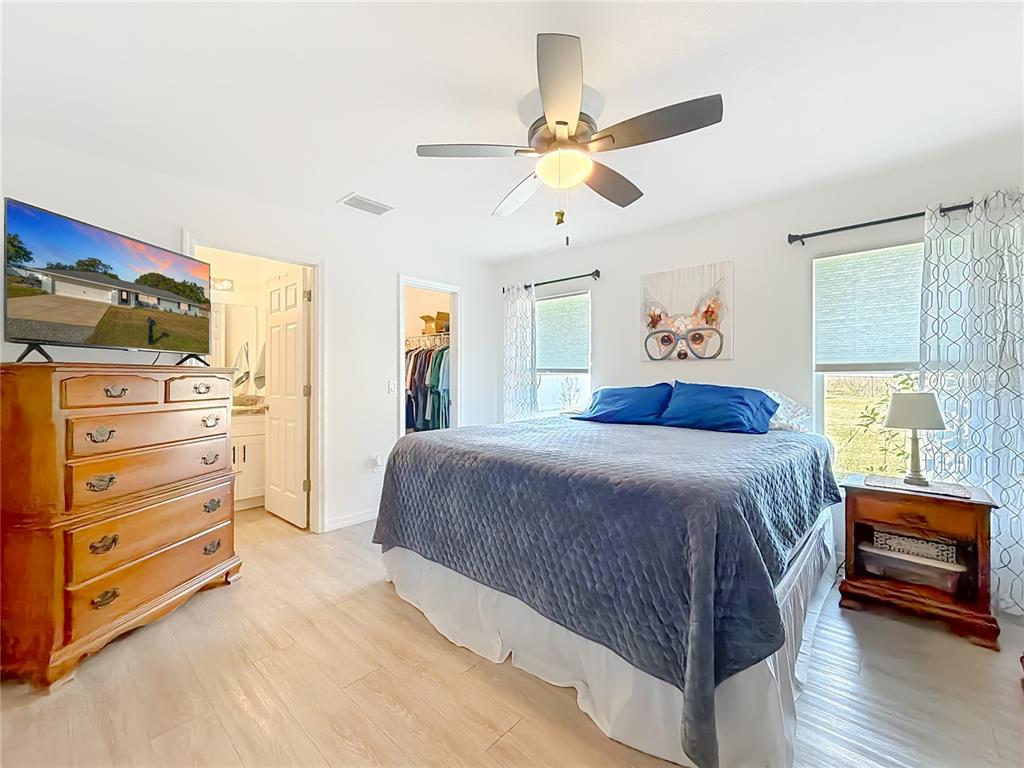 4445 East Maryland Street Inverness, FL 34453 - Photo 27 of 46 a bedroom with a bed and a chandelier