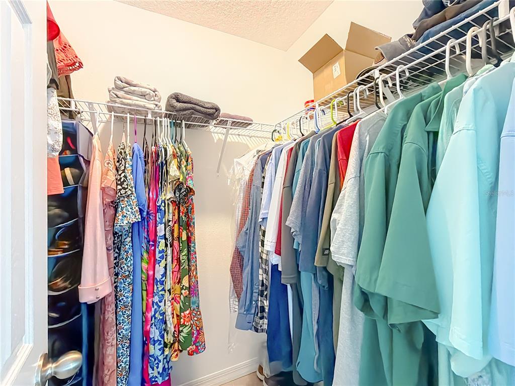 4445 East Maryland Street Inverness, FL 34453 - Photo 28 of 46 a view of walk in closet with clothes and shoes