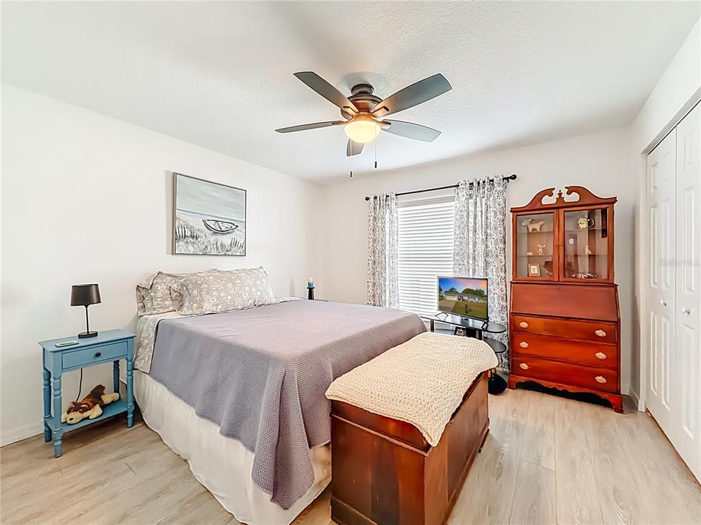 4445 East Maryland Street Inverness, FL 34453 - Photo 30 of 46 a bedroom with a bed and a chandelier