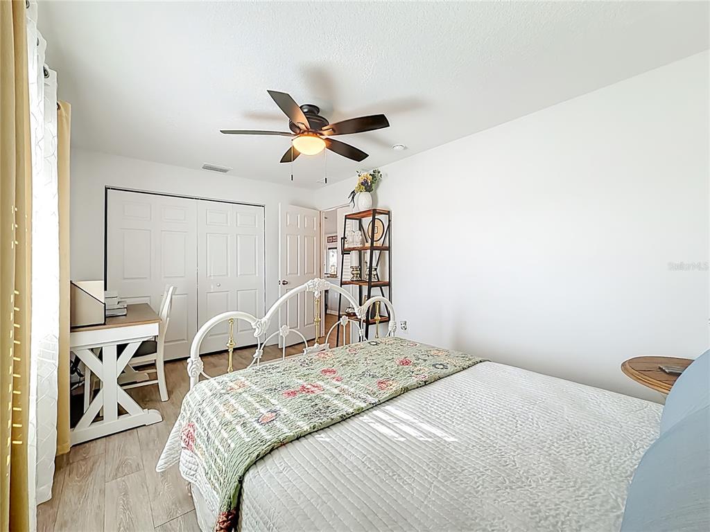 4445 East Maryland Street Inverness, FL 34453 - Photo 34 of 46 a bedroom with a bed and a chandelier