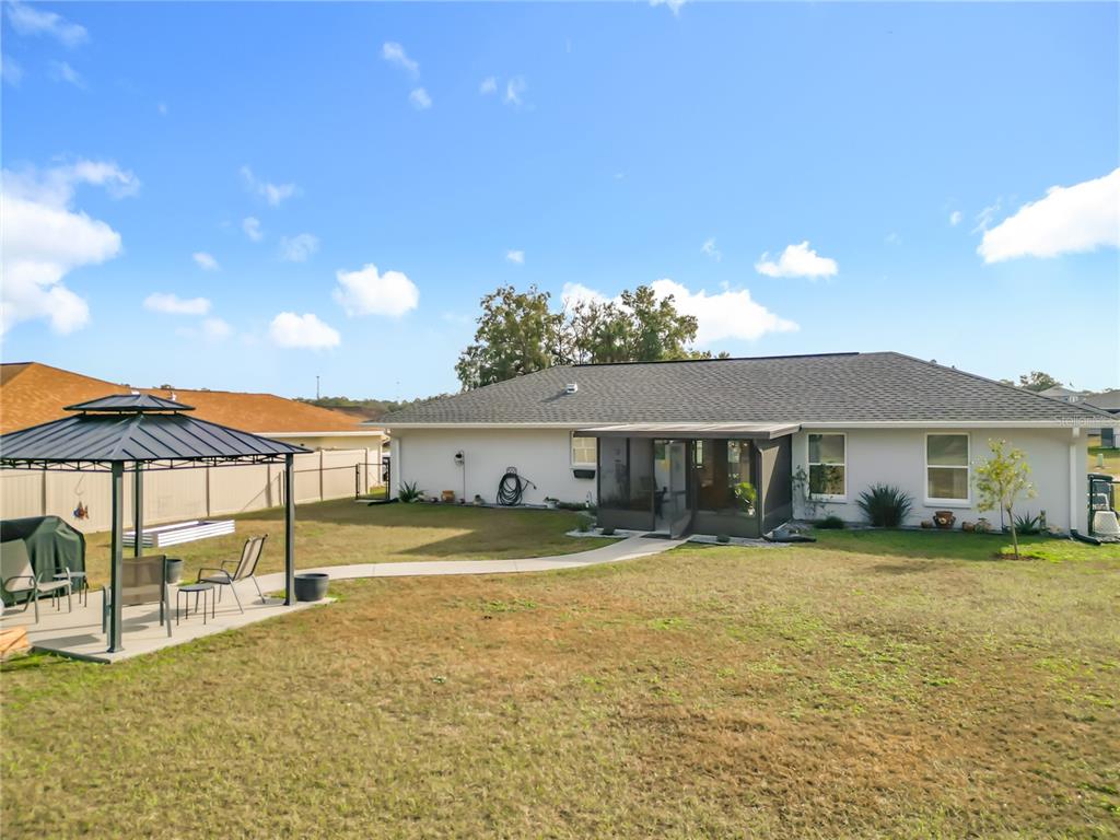 4445 East Maryland Street Inverness, FL 34453 - Photo 43 of 46 a view of a patio with a table and chairs under an umbrella